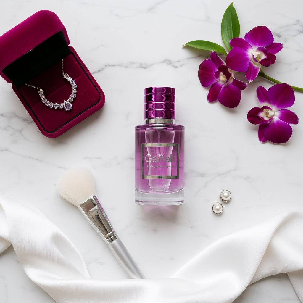 Ganelli No. 2 for Her perfume bottle, purple glass with magenta cap, on marble with orchids.